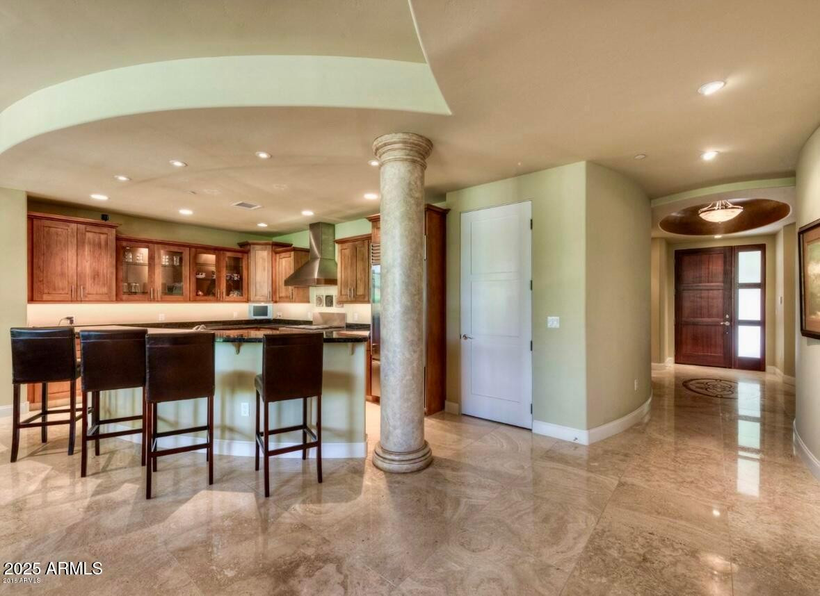 8 Biltmore Estate, Unit 112 Phoenix, AZ 85016 - Photo 8 of 14 a open kitchen with stainless steel appliances kitchen island granite countertop a refrigerator and cabinets