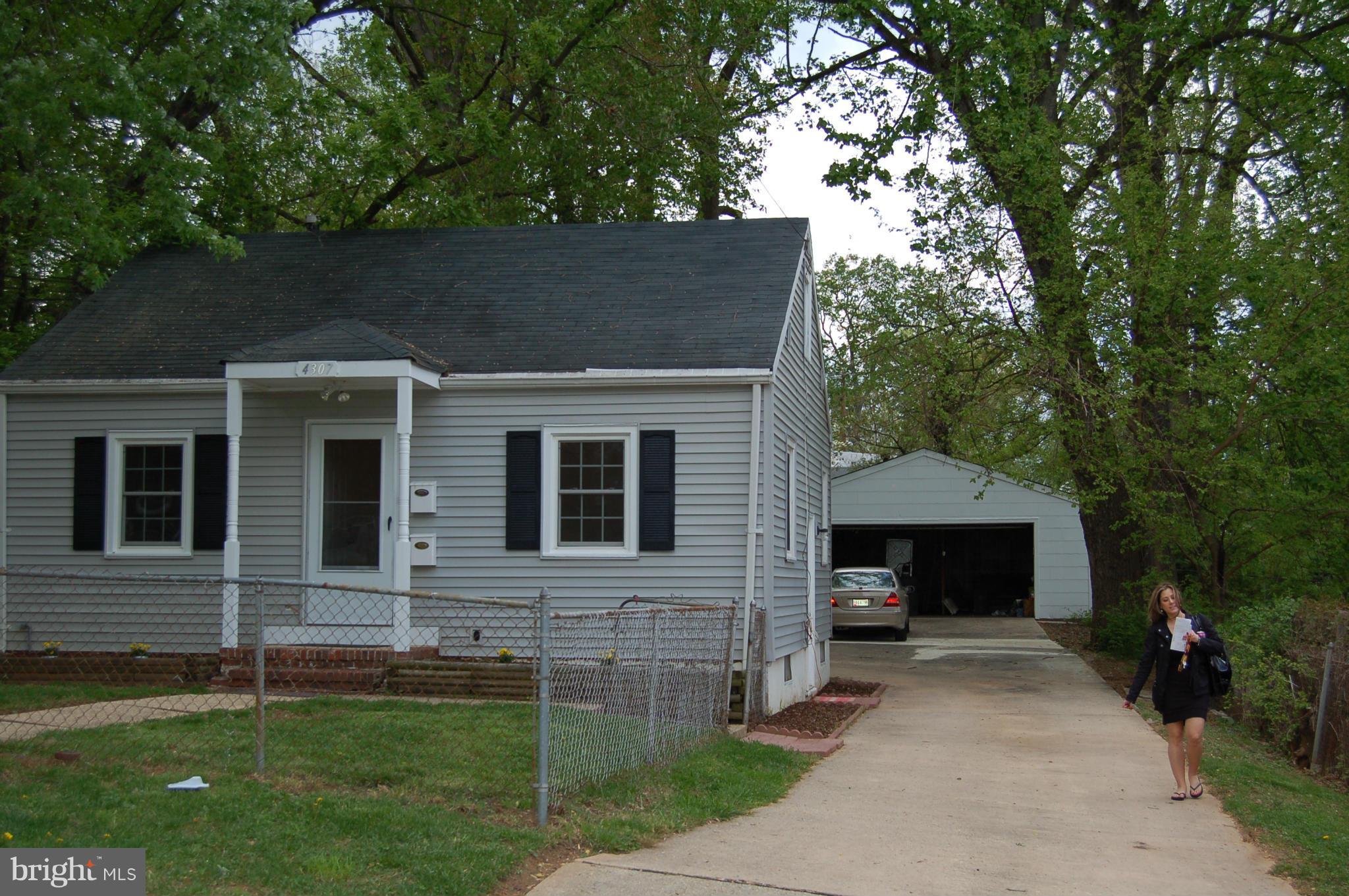4307 Fernhill Road Silver Spring, MD 20906 - Photo 1 of 8 a front view of a house with a garden and yard