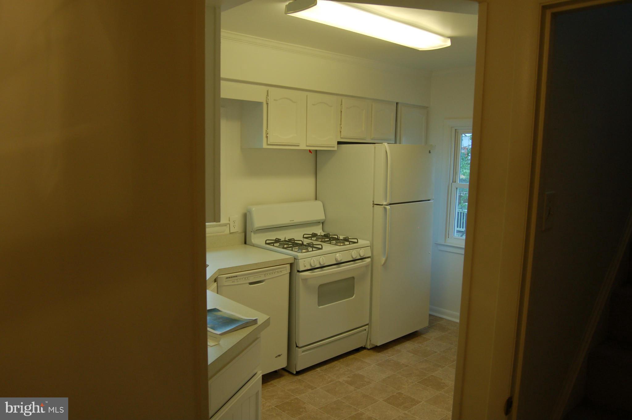 4307 Fernhill Road Silver Spring, MD 20906 - Photo 5 of 8 a kitchen with a stove and a refrigerator