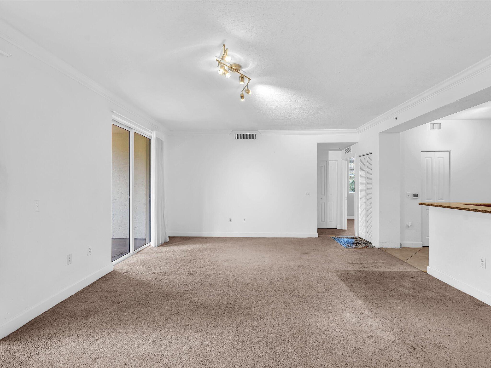 4303 Renaissance Way, Unit 303 Boynton Beach, FL 33426 - Photo 12 of 74 a view of a livingroom with a chandelier fan