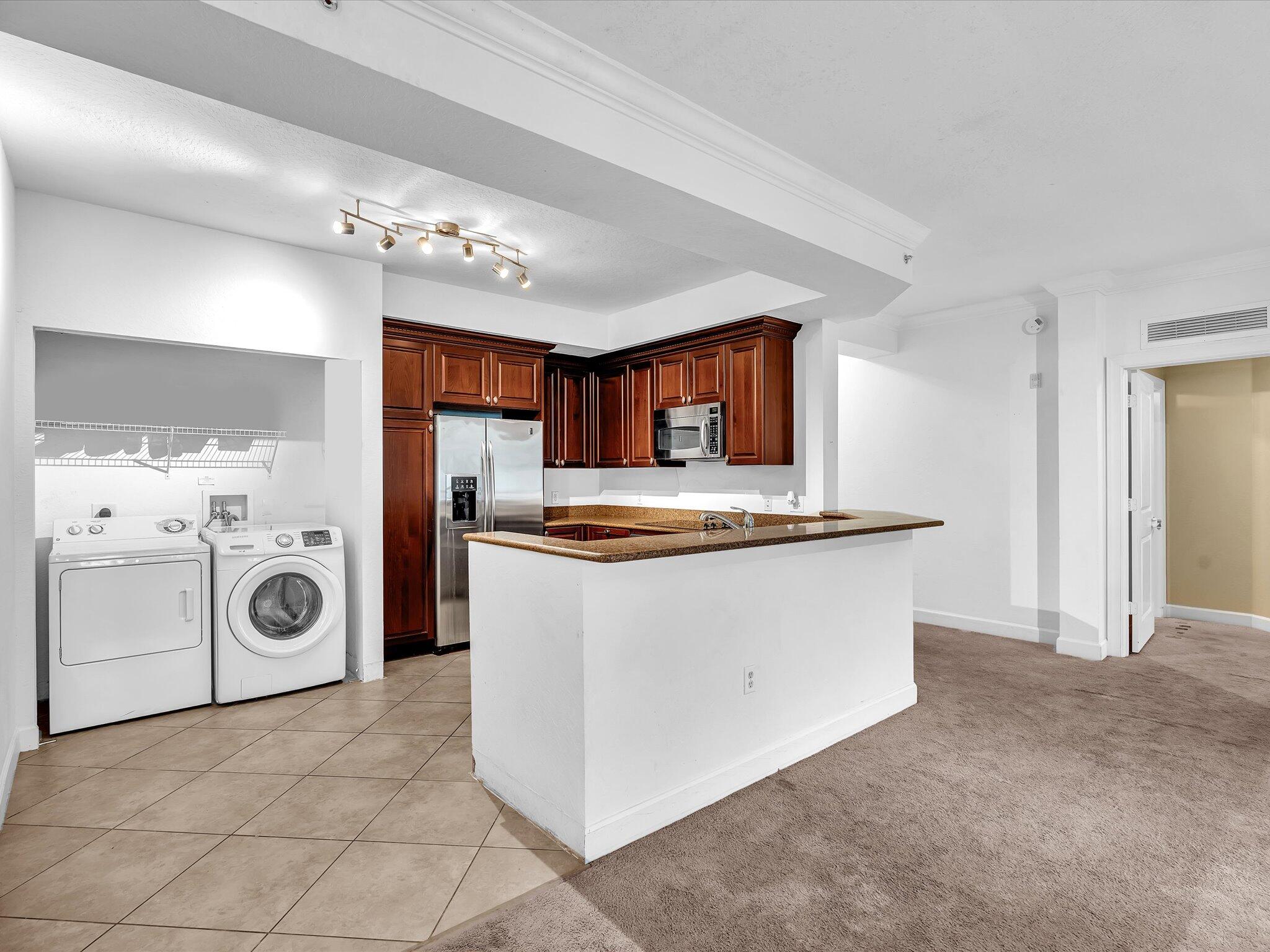 4303 Renaissance Way, Unit 303 Boynton Beach, FL 33426 - Photo 20 of 74 a view of kitchen cabinets and refrigerator