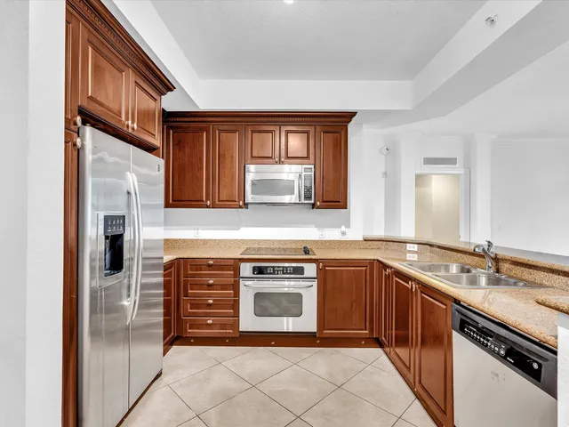 a view of a livingroom with a chandelier fan and windows