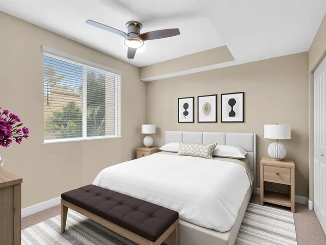 an empty room with closet and a chandelier fan