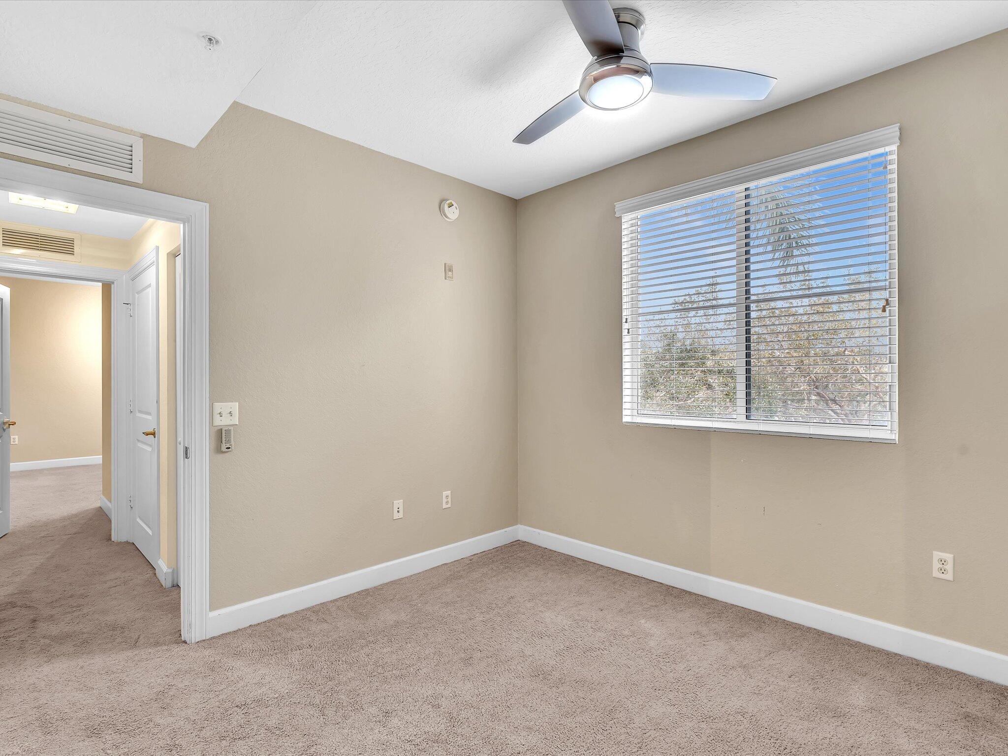 4303 Renaissance Way, Unit 303 Boynton Beach, FL 33426 - Photo 35 of 74 an empty room with a window and a ceiling fan