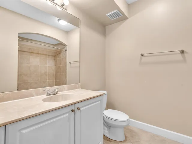 a bathroom with a granite countertop toilet a sink and bathtub