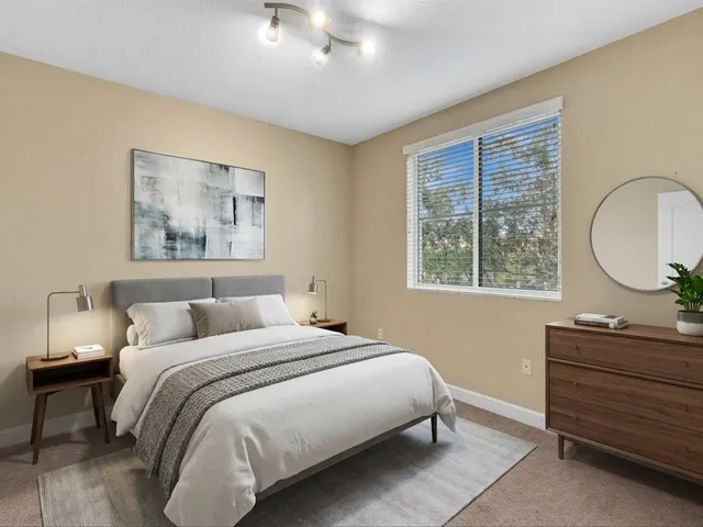 a living room with lots of furniture and view of kitchen