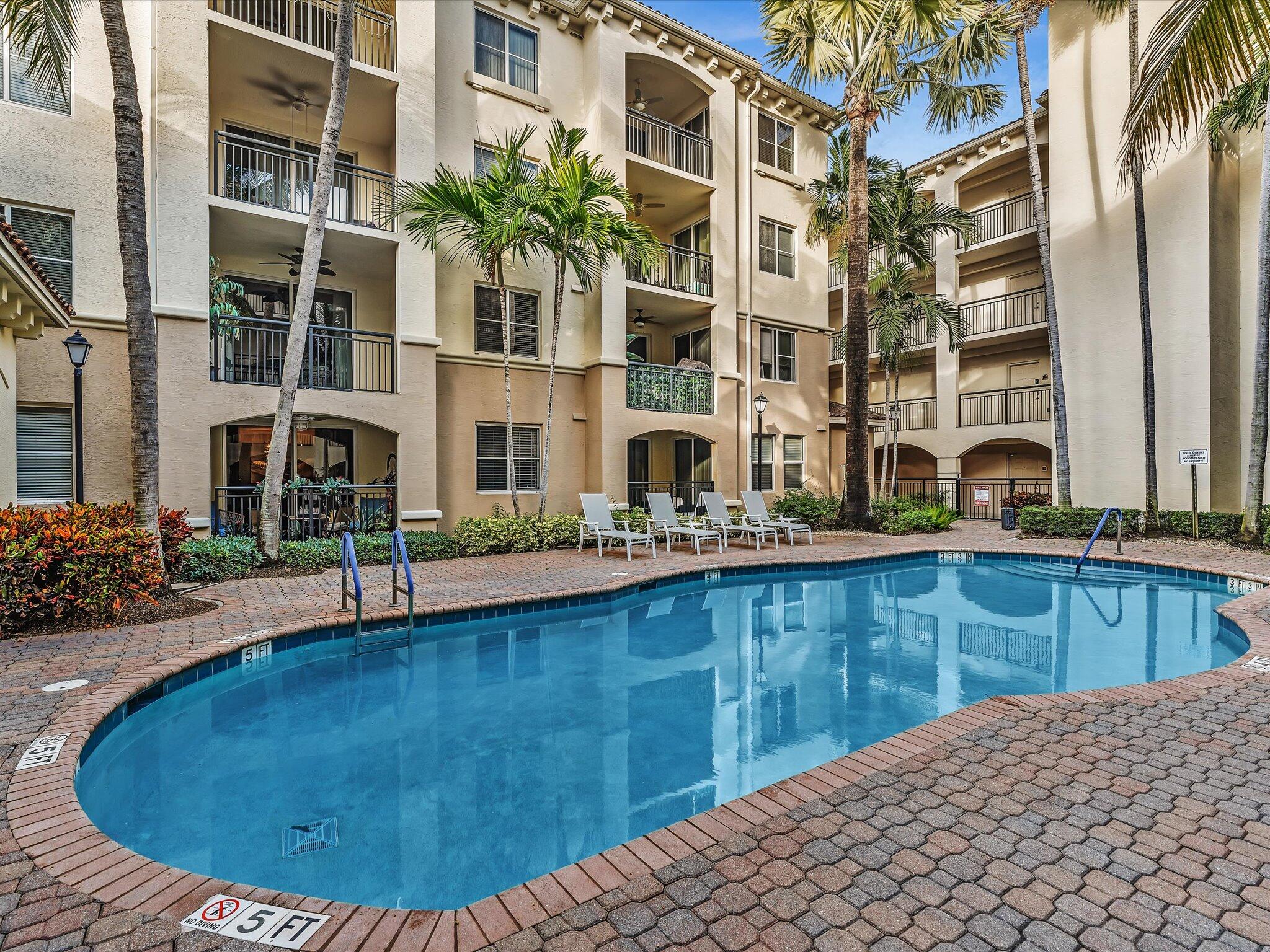 4303 Renaissance Way, Unit 303 Boynton Beach, FL 33426 - Photo 5 of 74 a view of a swimming pool with a lounge chairs