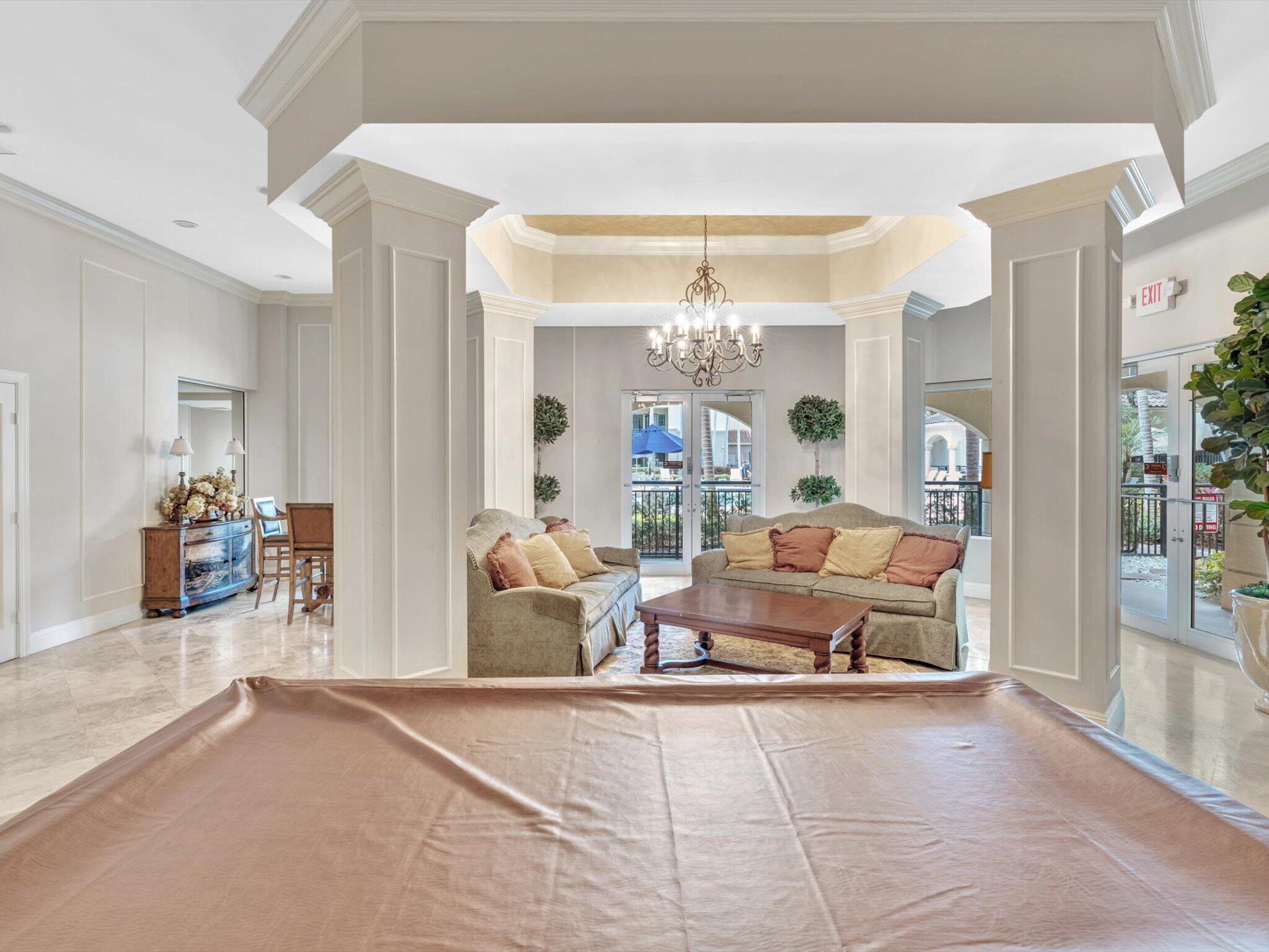 4303 Renaissance Way, Unit 303 Boynton Beach, FL 33426 - Photo 52 of 74 a living room with furniture and chandelier