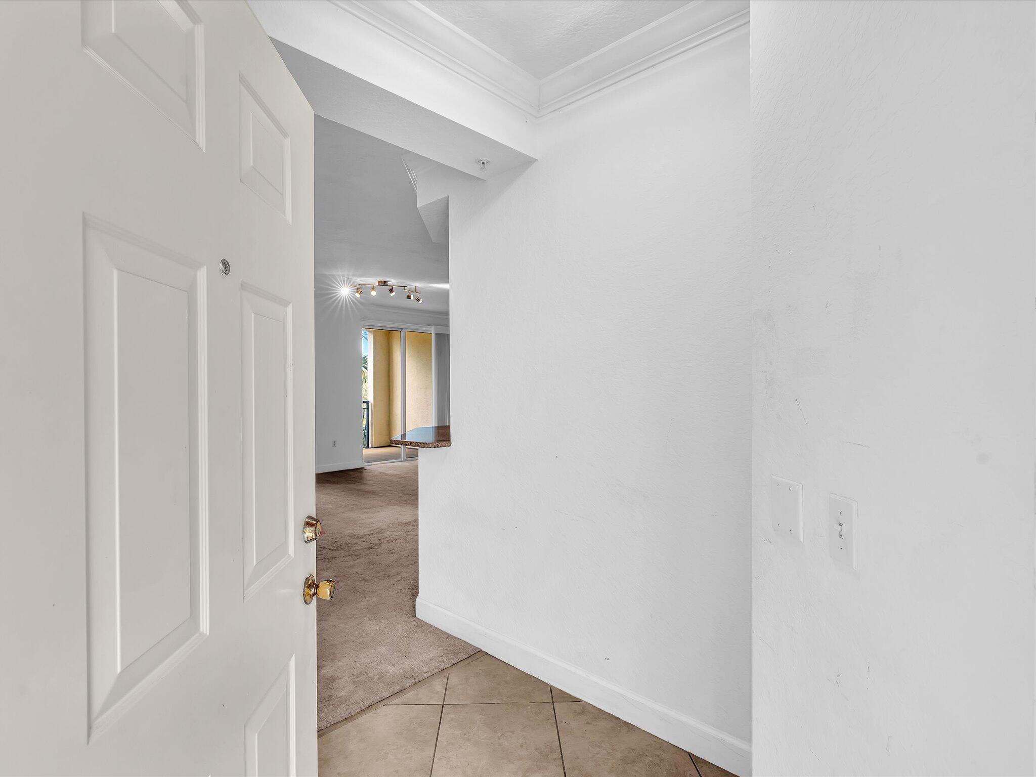 4303 Renaissance Way, Unit 303 Boynton Beach, FL 33426 - Photo 10 of 74 a view of a hallway with wooden floor
