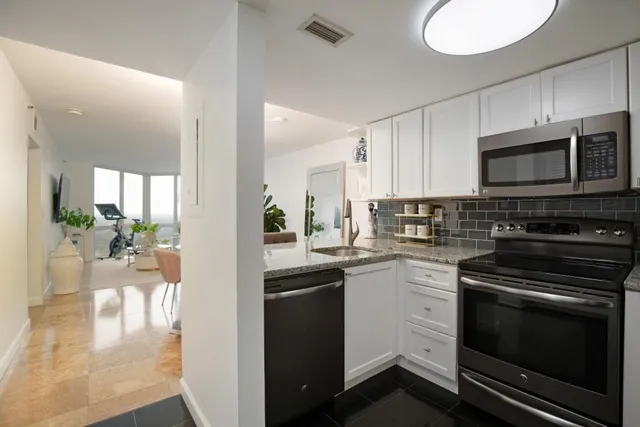 a kitchen with a sink stove and microwave