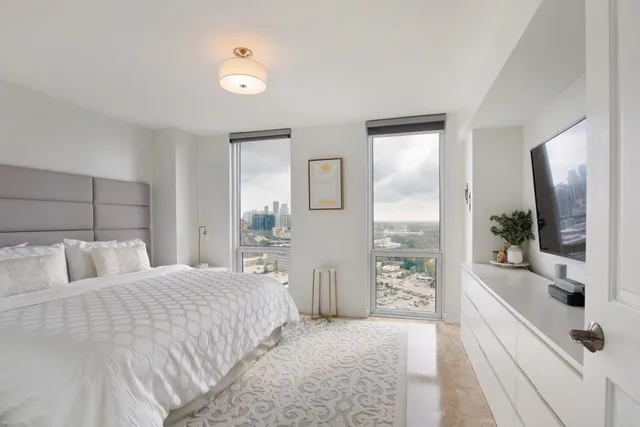 a bedroom with a large bed and a couch