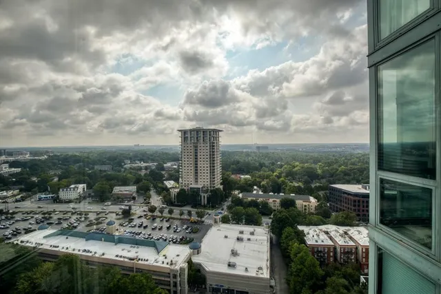 a view of hallway with a couch and a window