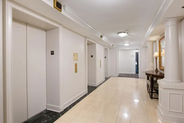 a living room with fireplace furniture and a chandelier
