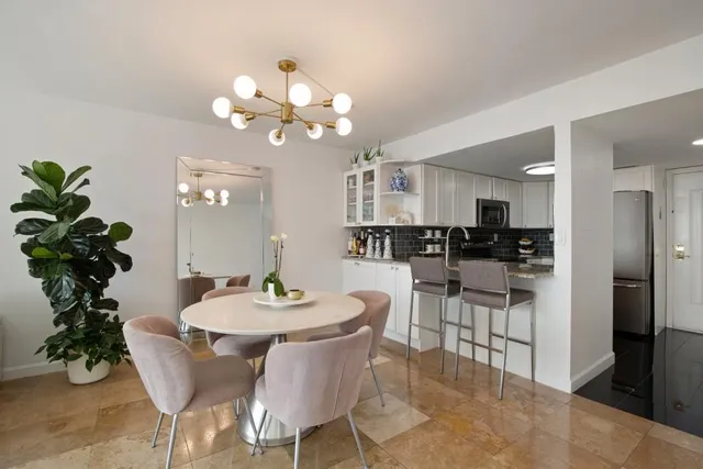 a dining room with furniture and chandelier