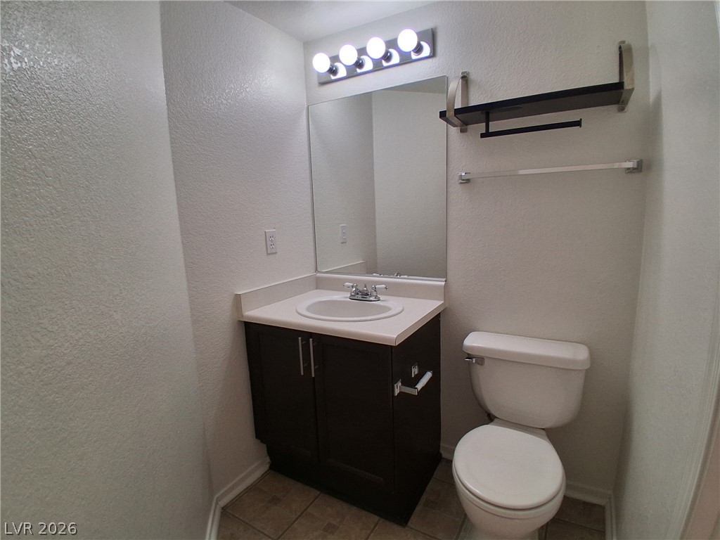 8023 Simone Avenue Las Vegas, NV 89147 - Photo 7 of 12 A well-appointed lavatory featuring a vanity, mirror, and modern fixtures.
