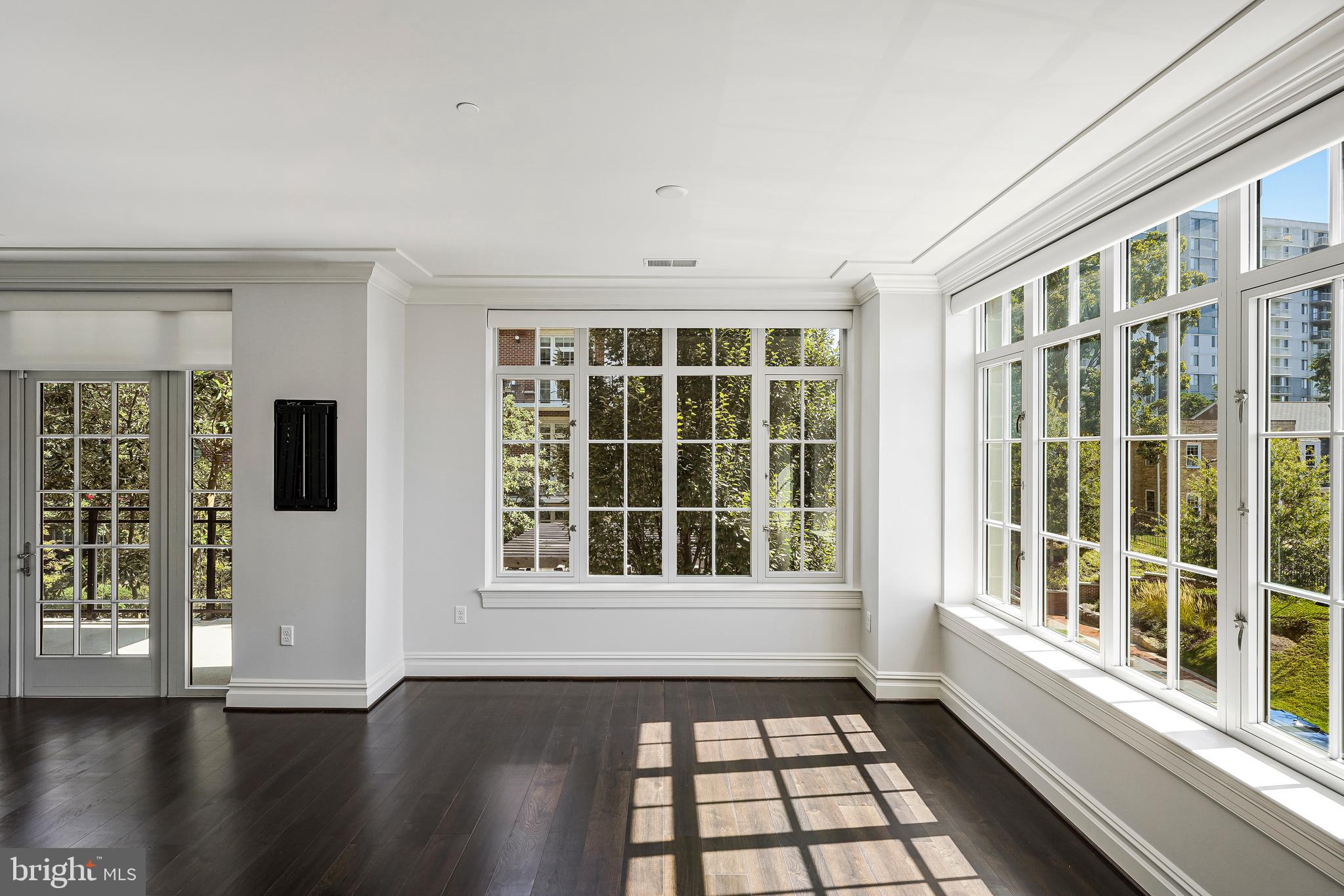 6900 Fleetwood Road, Unit 317 McLean, VA 22101 - Photo 12 of 56 a view of an empty room with a window and wooden floor
