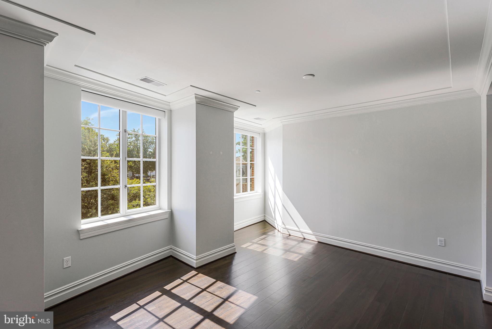 6900 Fleetwood Road, Unit 317 McLean, VA 22101 - Photo 14 of 56 a view of an empty room with a window and wooden floor