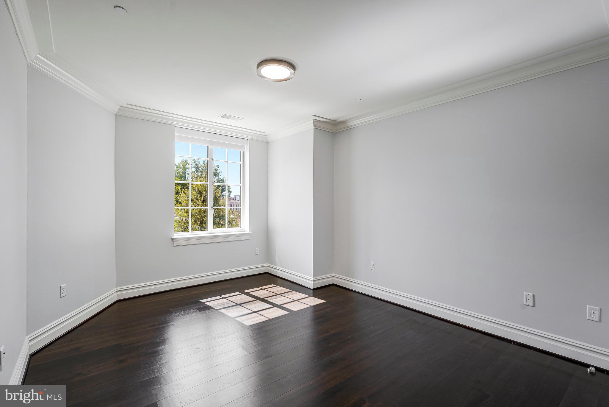 6900 Fleetwood Road, Unit 317 McLean, VA 22101 - Photo 22 of 56 an empty room with wooden floor and windows