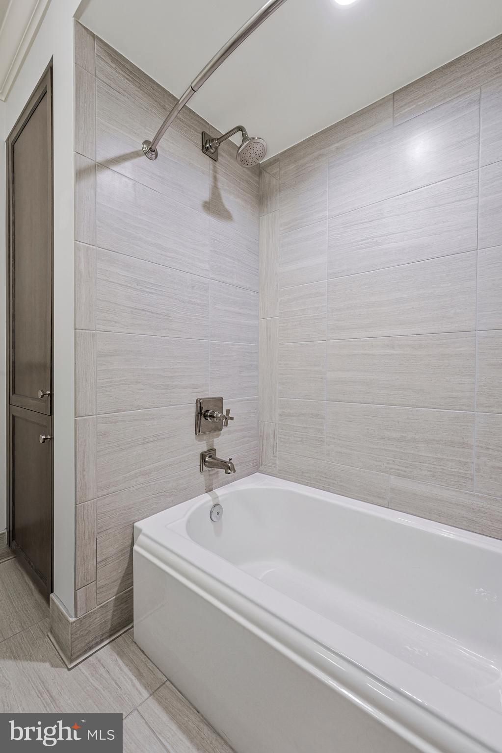 6900 Fleetwood Road, Unit 317 McLean, VA 22101 - Photo 26 of 56 a bathroom with a bathtub and a shower