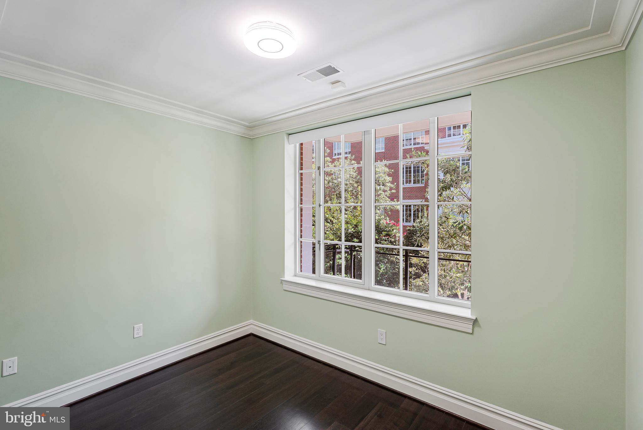 6900 Fleetwood Road, Unit 317 McLean, VA 22101 - Photo 27 of 56 an empty room with wooden floor and windows