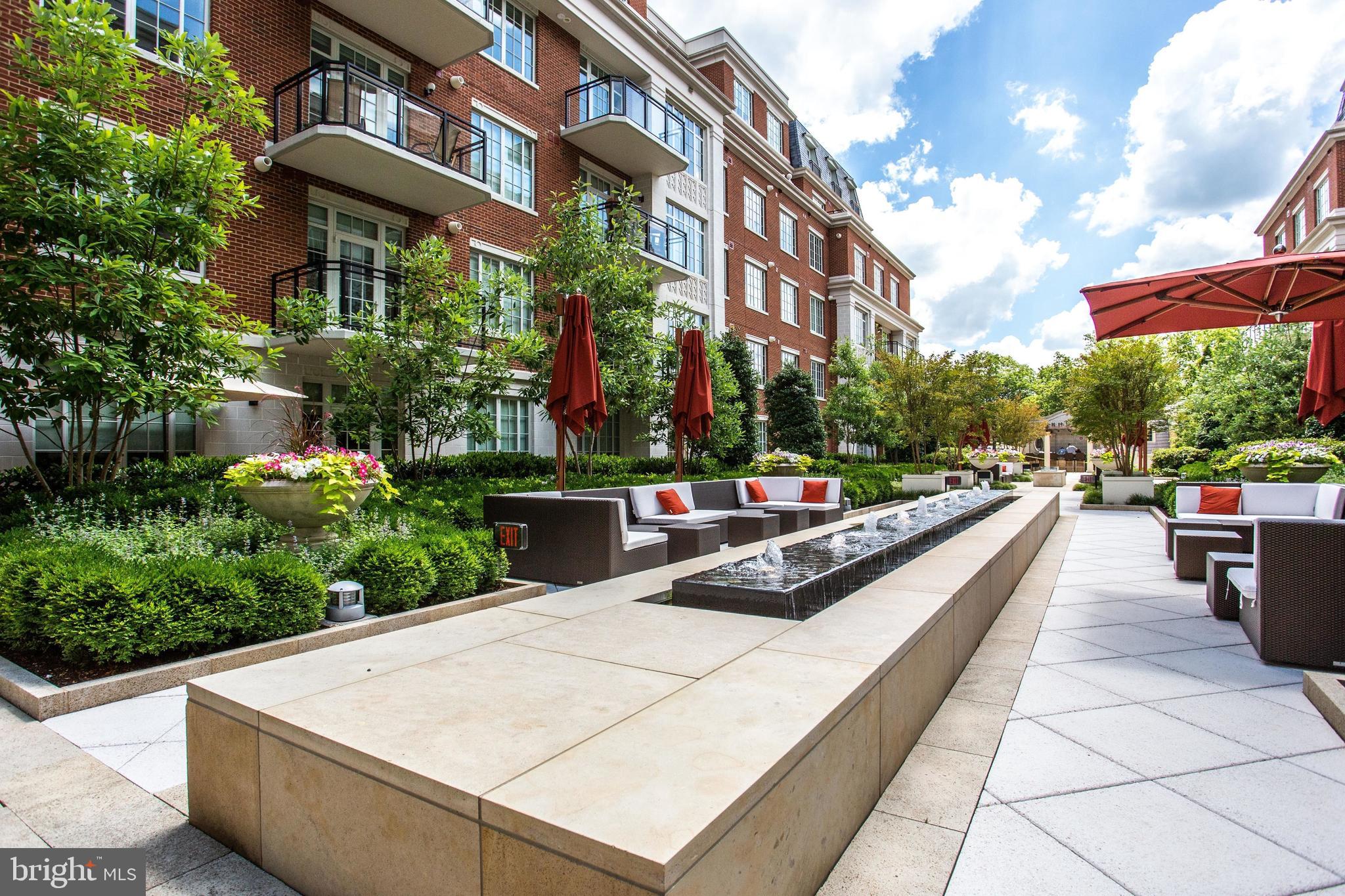 6900 Fleetwood Road, Unit 317 McLean, VA 22101 - Photo 34 of 56 a swimming pool with outdoor seating and yard