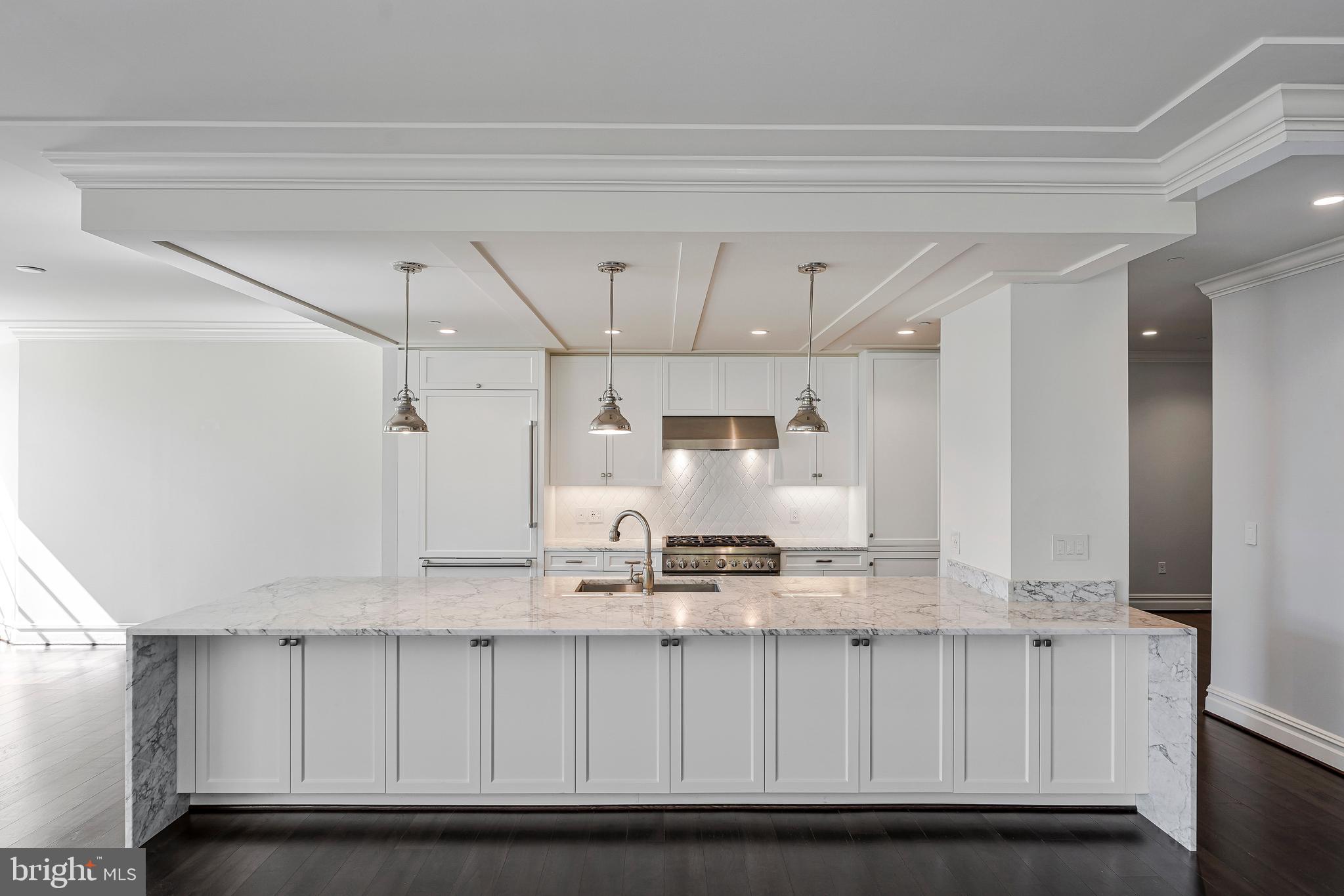 6900 Fleetwood Road, Unit 317 McLean, VA 22101 - Photo 6 of 56 a kitchen with kitchen island granite countertop white cabinets and stainless steel appliances