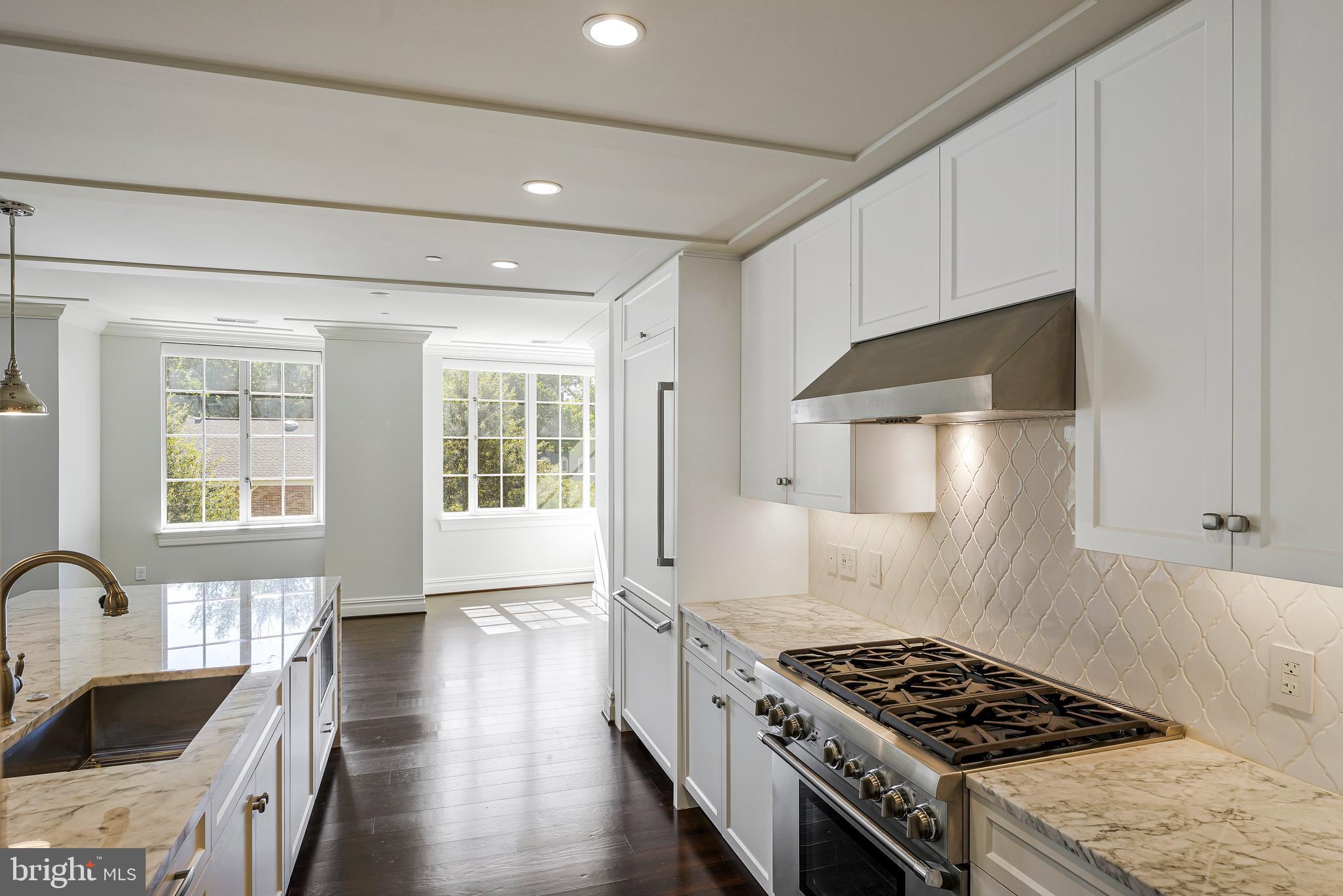 6900 Fleetwood Road, Unit 317 McLean, VA 22101 - Photo 9 of 56 a kitchen with stainless steel appliances granite countertop a stove a sink dishwasher and a stove with wooden floor
