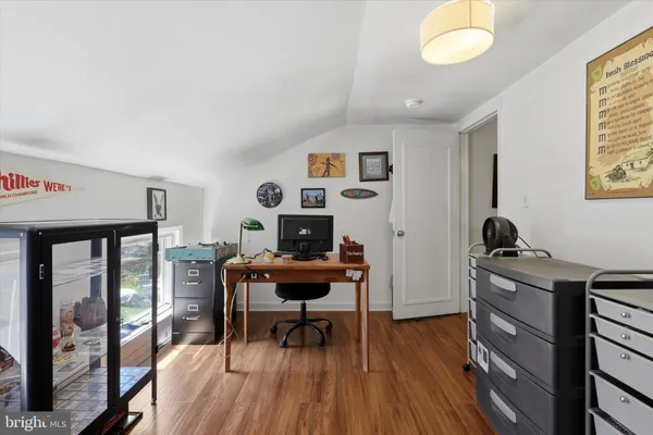 a living room with furniture gym equipment and a large window