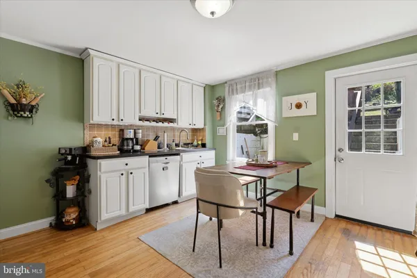 a kitchen with a refrigerator and cabinets