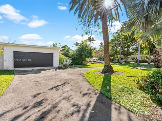 a view of a hallway with wooden floor and entryway