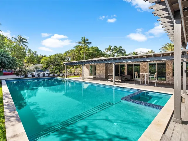 a spacious bedroom with a bed and a flat screen tv