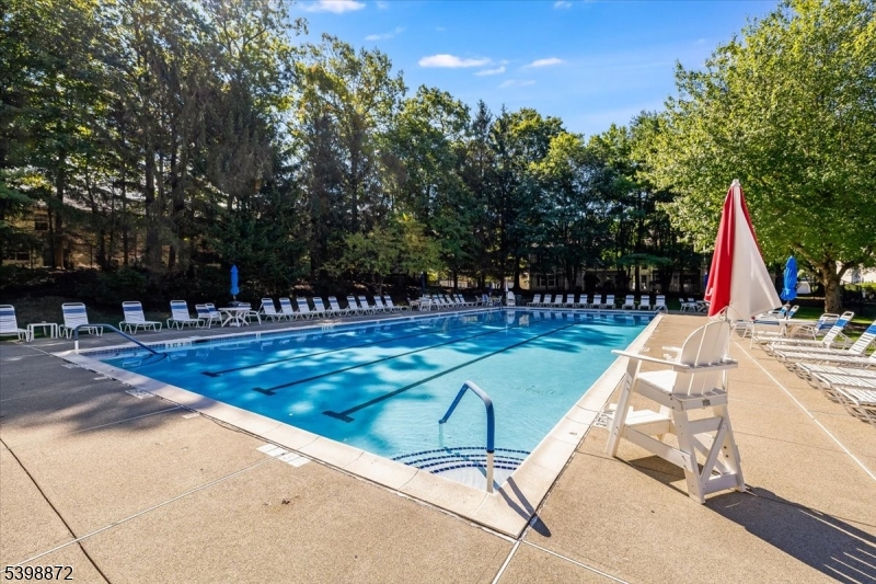 56 Maple Lane Mount Arlington, NJ 07856 - Photo 24 of 34 a view of a swimming pool with a bench and trees