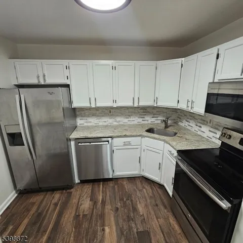 a kitchen with a sink stove and refrigerator
