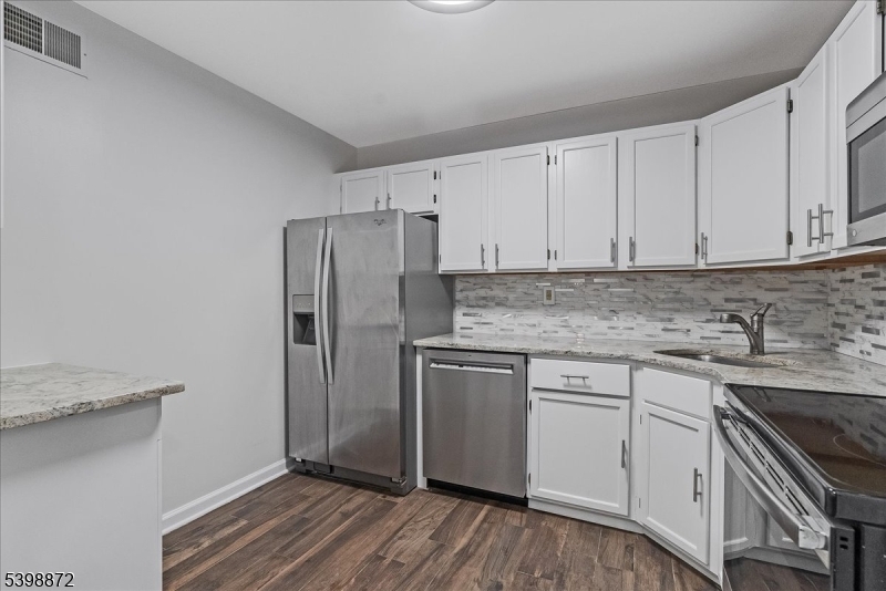 56 Maple Lane Mount Arlington, NJ 07856 - Photo 9 of 34 a kitchen with stainless steel appliances granite countertop a stove a sink and a refrigerator