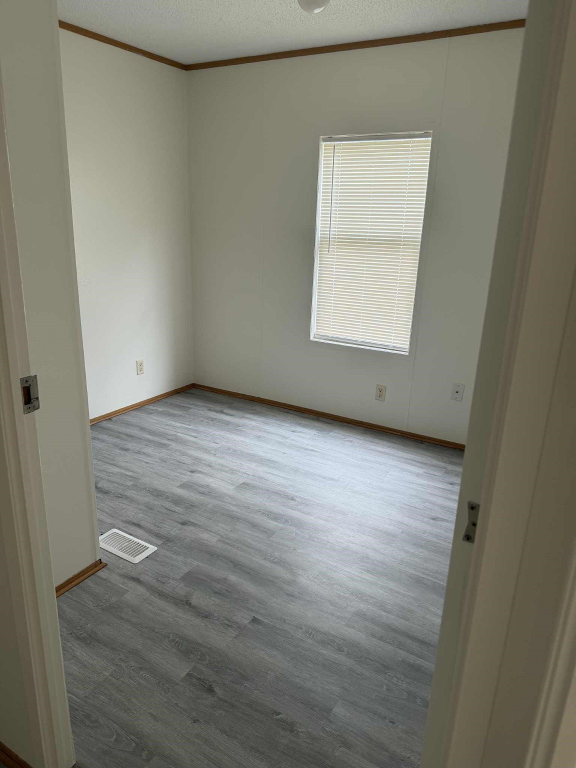 24455 Needham Road Porter, TX 77365 - Photo 4 of 8 an empty room with wooden floor and windows