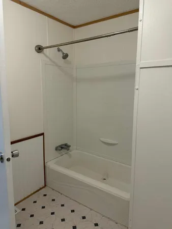 a bathroom with a shower and a bath tub