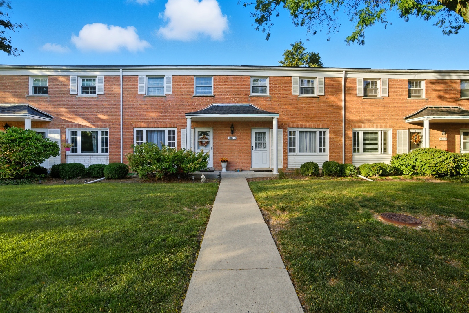 2132 Rugen Road, Unit E Glenview, IL 60026 - Photo 1 of 1 a front view of a house with garden