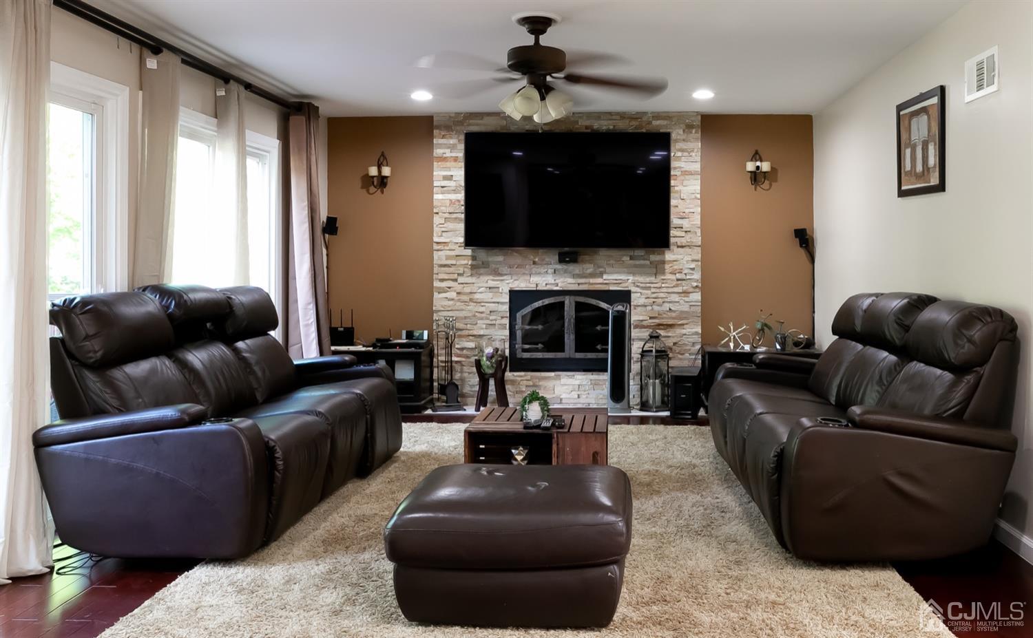 8 Peppermint Hill Road North Brunswick, NJ 08902 - Photo 15 of 32 a living room with furniture a fireplace and a flat screen tv