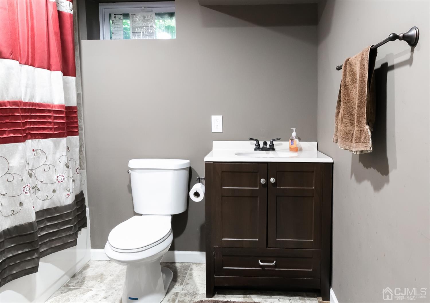 8 Peppermint Hill Road North Brunswick, NJ 08902 - Photo 32 of 32 a bathroom with a sink a toilet and shower curtain
