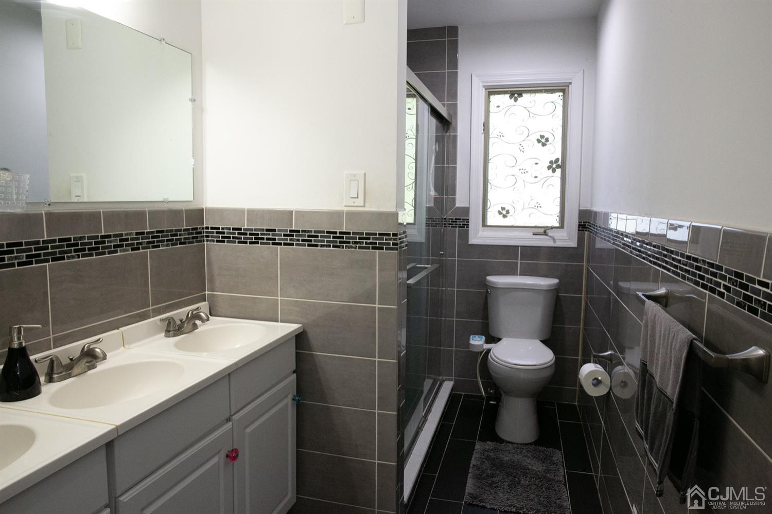8 Peppermint Hill Road North Brunswick, NJ 08902 - Photo 9 of 32 a bathroom with a sink toilet a mirror and shower