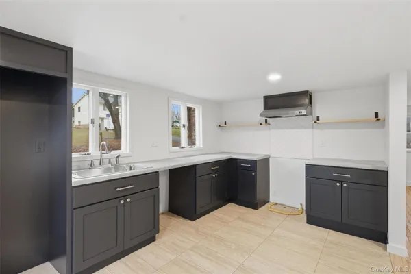 a kitchen with a sink stove and refrigerator