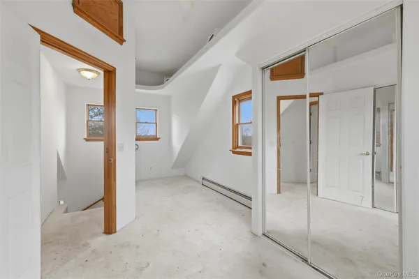 a view of an empty room with painting on the wall