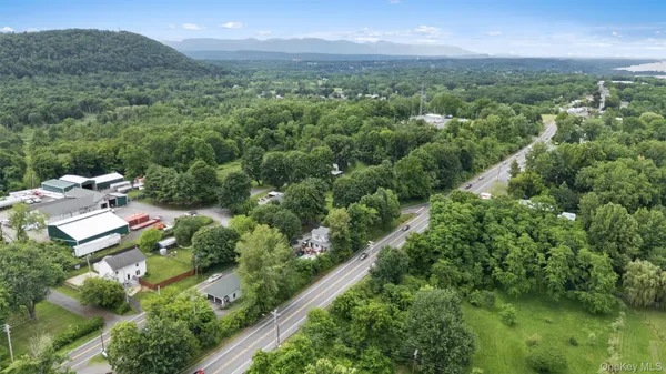 an aerial view of residential houses with outdoor space and trees