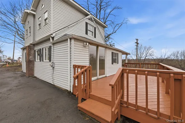 a view of a house with wooden fence