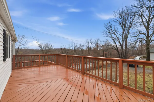 a view of balcony with wooden floor and fence