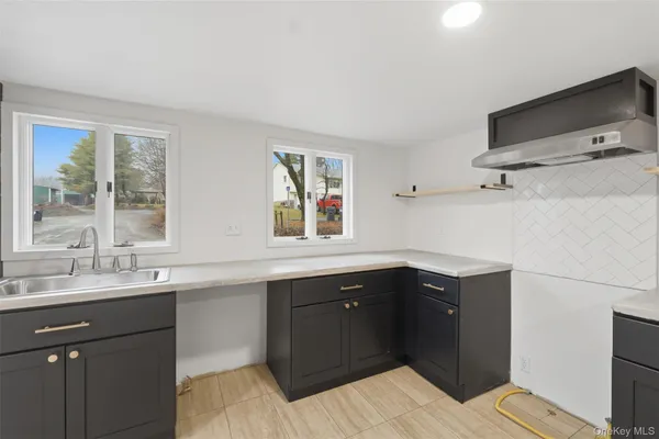 a kitchen with a sink and a window