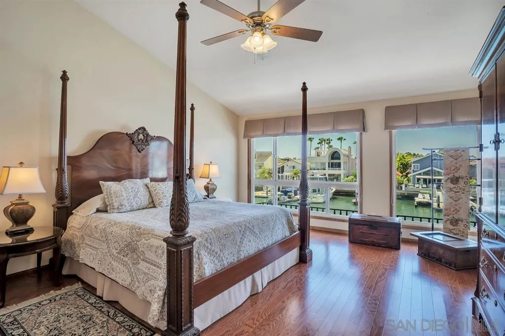 26 The Point Coronado, CA 92118 - Photo 12 of 23 a bedroom with a large bed and a chandelier