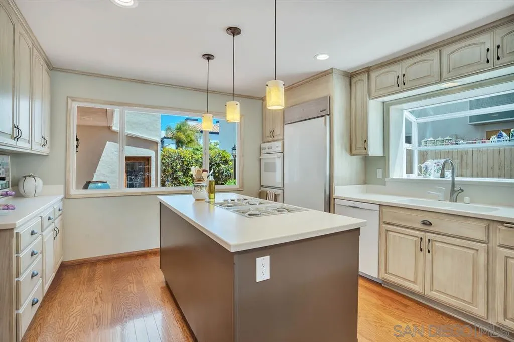 26 The Point Coronado, CA 92118 - Photo 7 of 23 a kitchen that has a sink a stove and a wooden floor