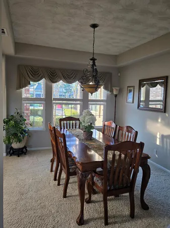 a kitchen with granite countertop a sink stainless steel appliances and cabinets