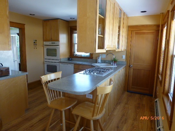 45 Monterey Road Worcester, MA 01606 - Photo 8 of 15 a kitchen with stainless steel appliances granite countertop a table chairs and a refrigerator